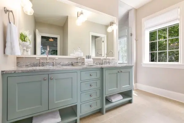 beautiful bathroom with mint green cabinets