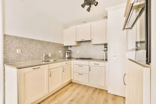 a kitchen with white cabinetry and a counter top