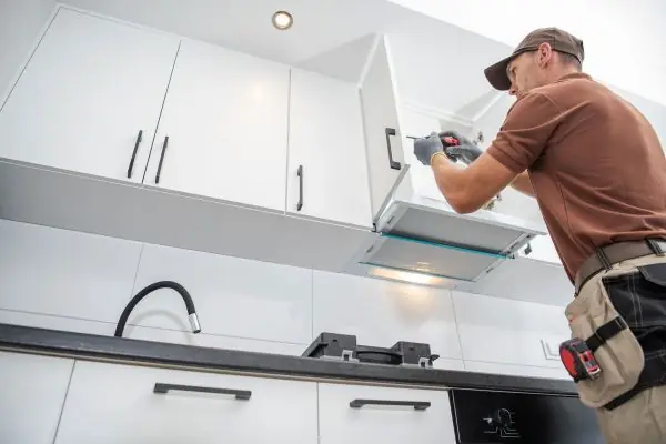 contractor worker assembling new kitchen cabinets