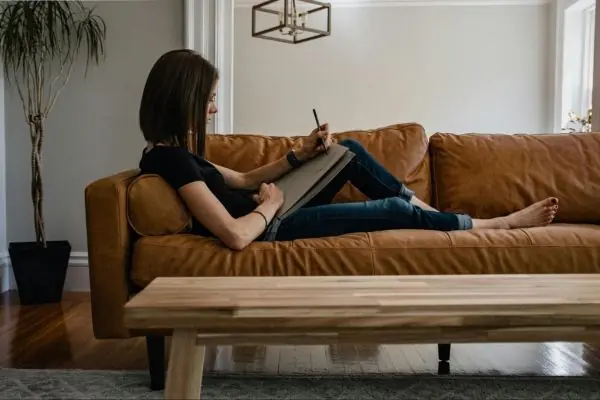 woman sitting on a custom made sofa set with a wooden table