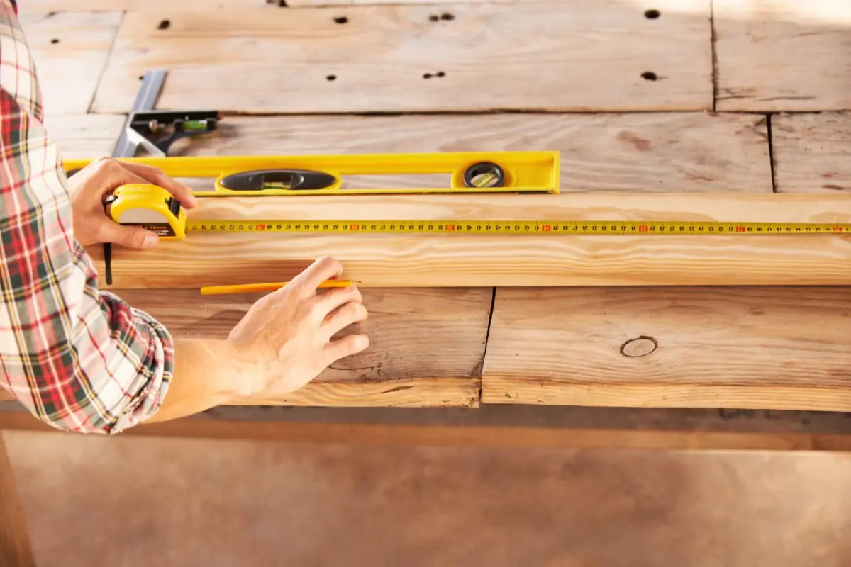 a handyman getting his measurement and double checking