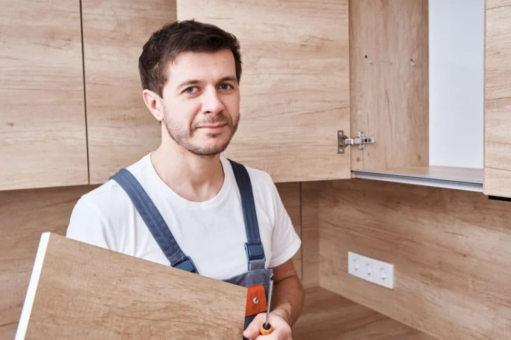 man assembling the custom kitchen cabinet