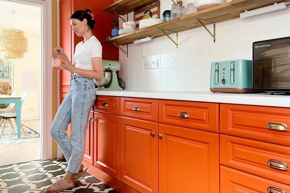 woman relaxing in kitchen with custom cabinets