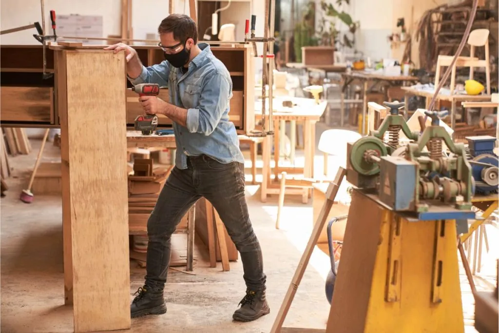 craftsman as furniture maker with face mask