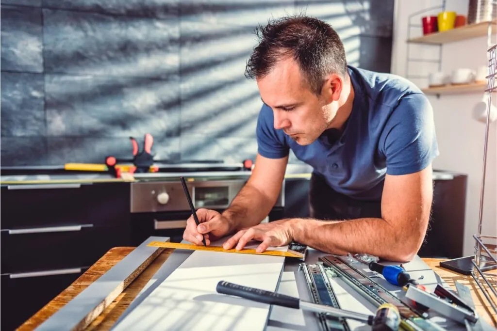 man building kitchen cabinets